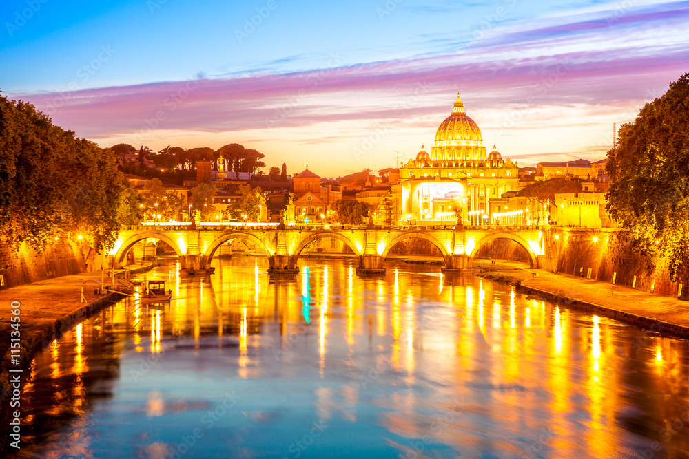Rome skyline at evening with San Pietro basilica illuminated by city lights of Rome, Italy.