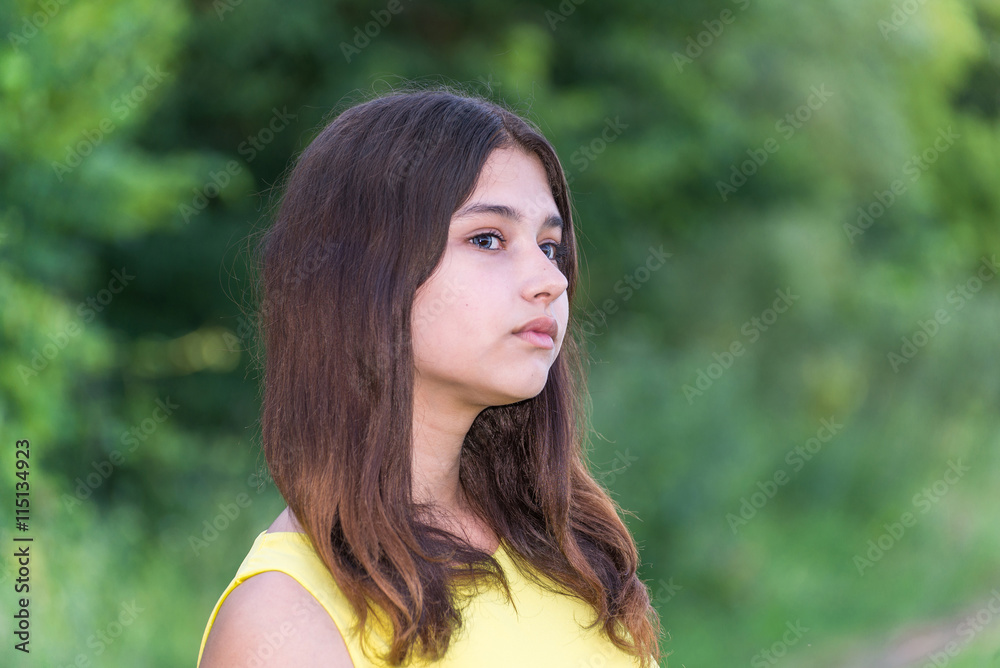 beautiful girl 14 years old posing on nature of summer