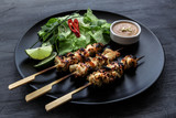 Satay is a Malaysian-style kebab. It  served with  peanut sauce, slivers of cucumbers and onions.