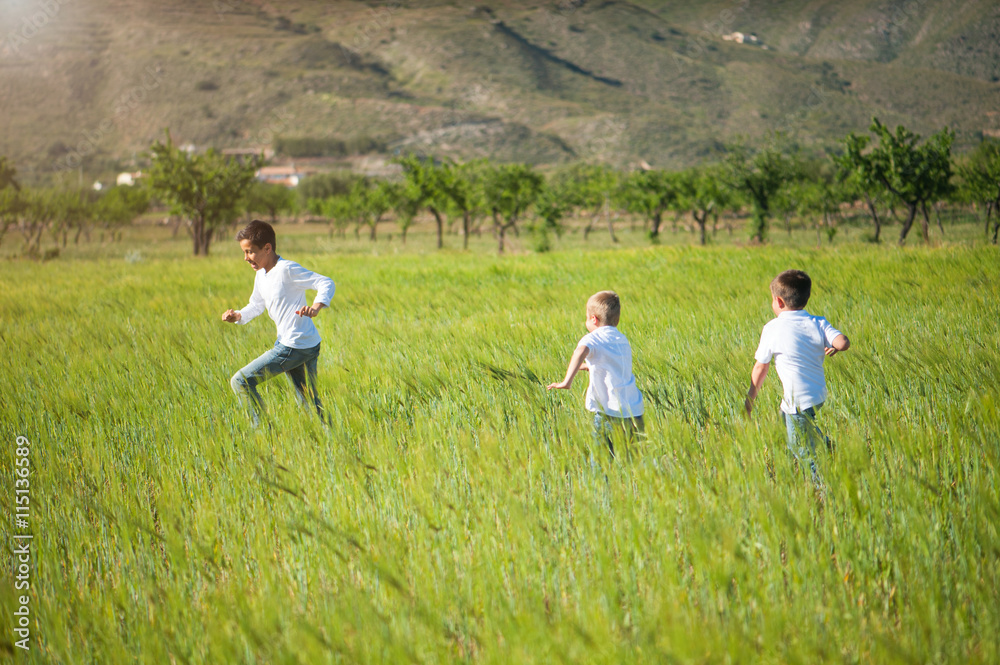 boy running in a field boy running in a field
