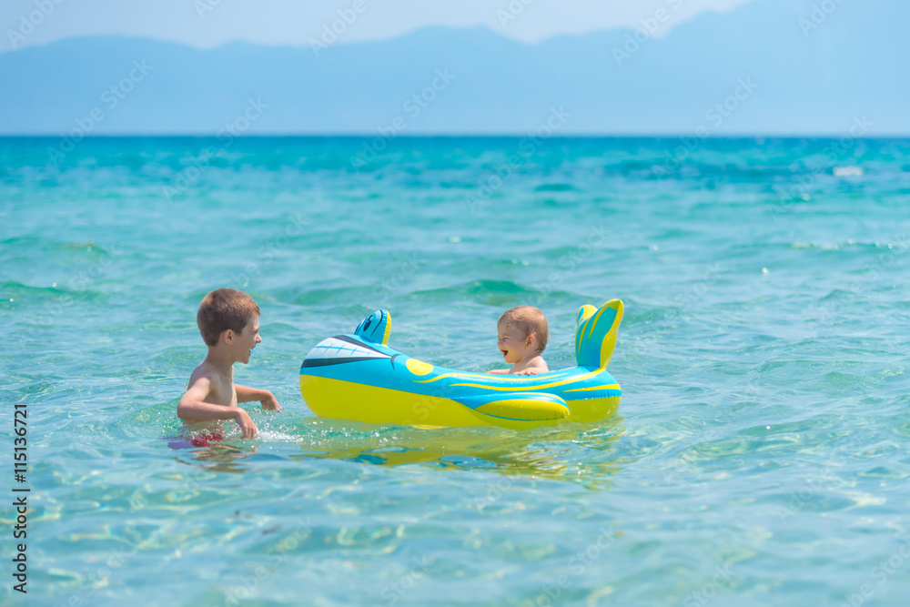 Beautiful baby girl playing in a inflatable boat at the beach Beautiful baby girl playing in a inflatable boat at the beach
