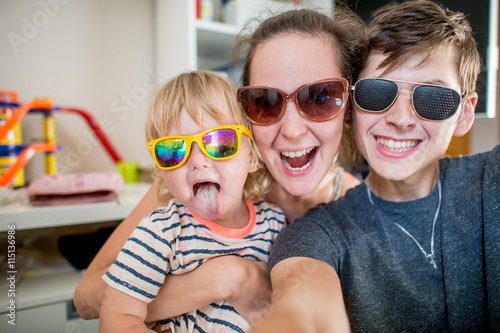 Cheerful family posing together for photo selfie