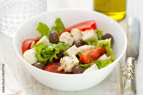 salad cheese with vegetables in white bowl