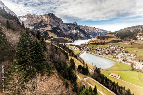 Holiday in Switzerland - Beautiful foggy view of winter landscape towards Engelberg, Switzerland