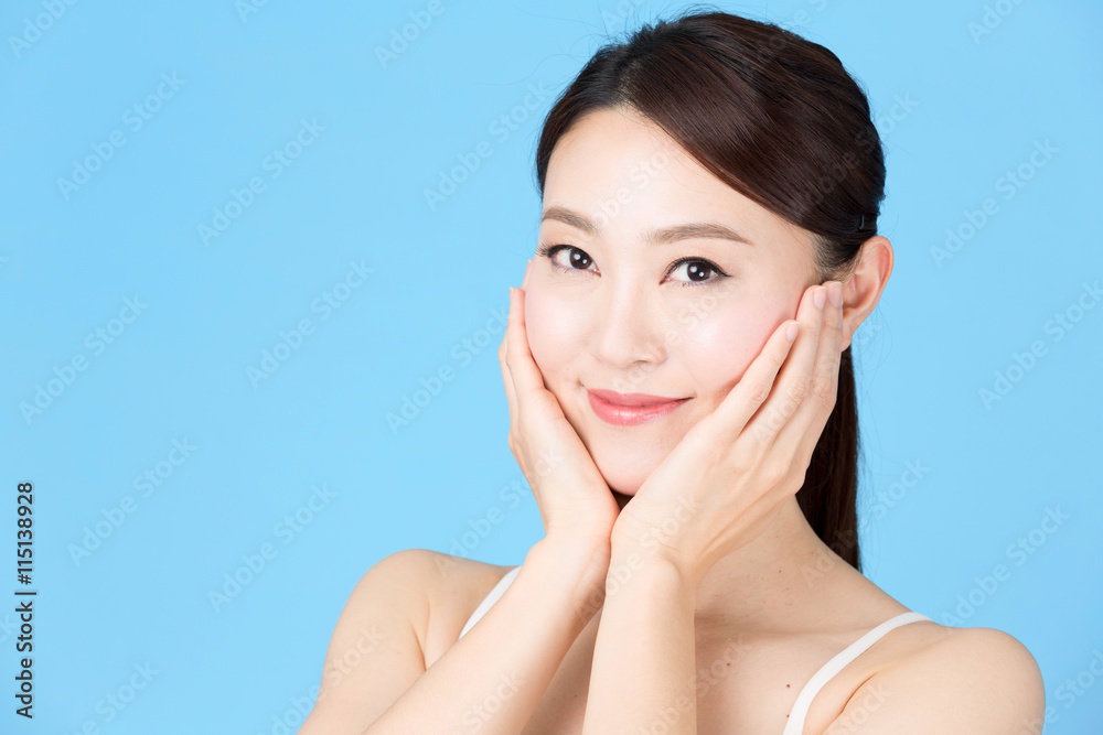attractive asian woman isolated on blue background attractive asian woman isolated on blue background