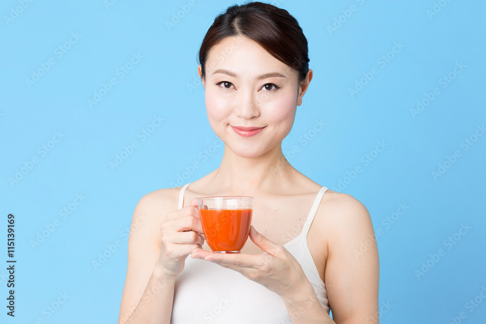 attractive asian woman isolated on blue background attractive asian woman isolated on blue background