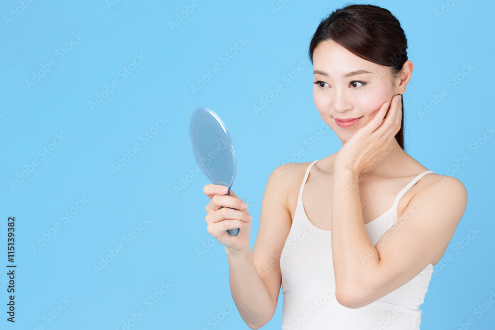 attractive asian woman isolated on blue background attractive asian woman isolated on blue background
