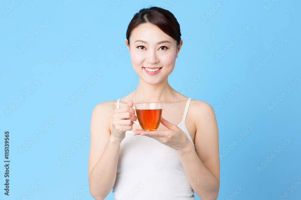 attractive asian woman isolated on blue background attractive asian woman isolated on blue background