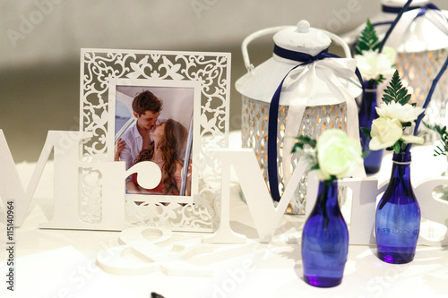 Lettering Mr & Mrs stand behind a newlyweds photo put in frame