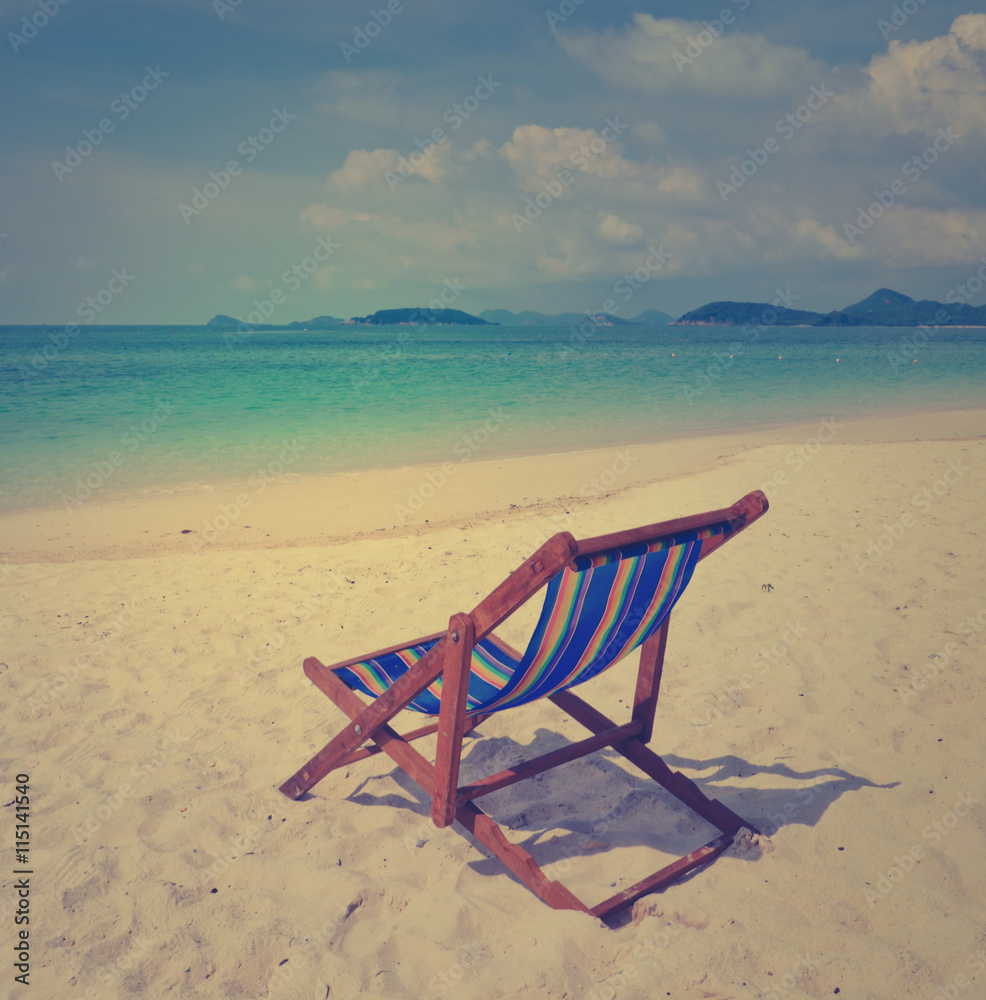 Tropical beach with colorful beach chair, Thailand. Vintage filtered effect image.
