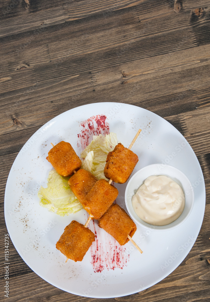 fried mozzarella cheese sticks breaded with sauce on plate