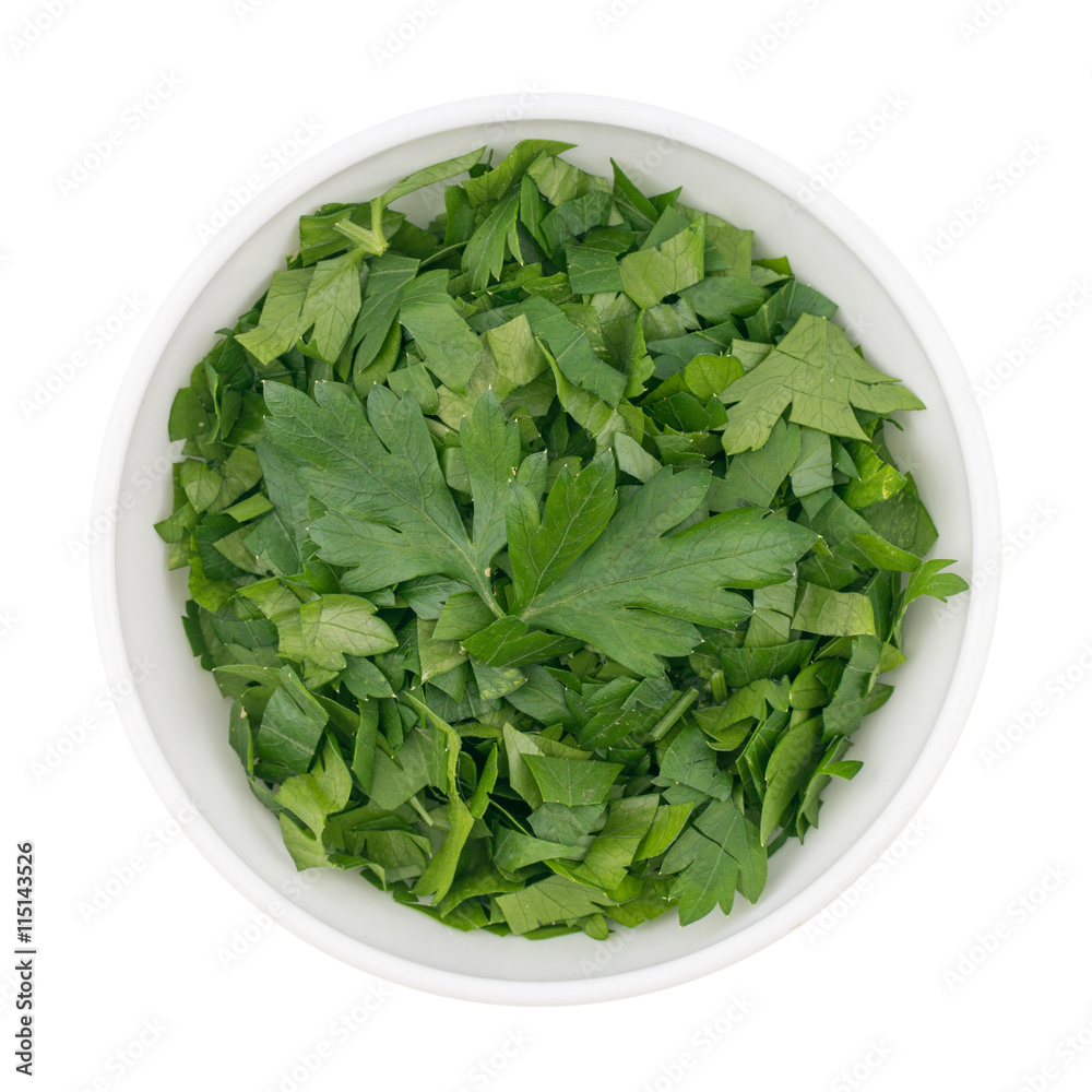 bowl of chopped parsley leaves isolated on white background bowl of chopped parsley leaves isolated on white background