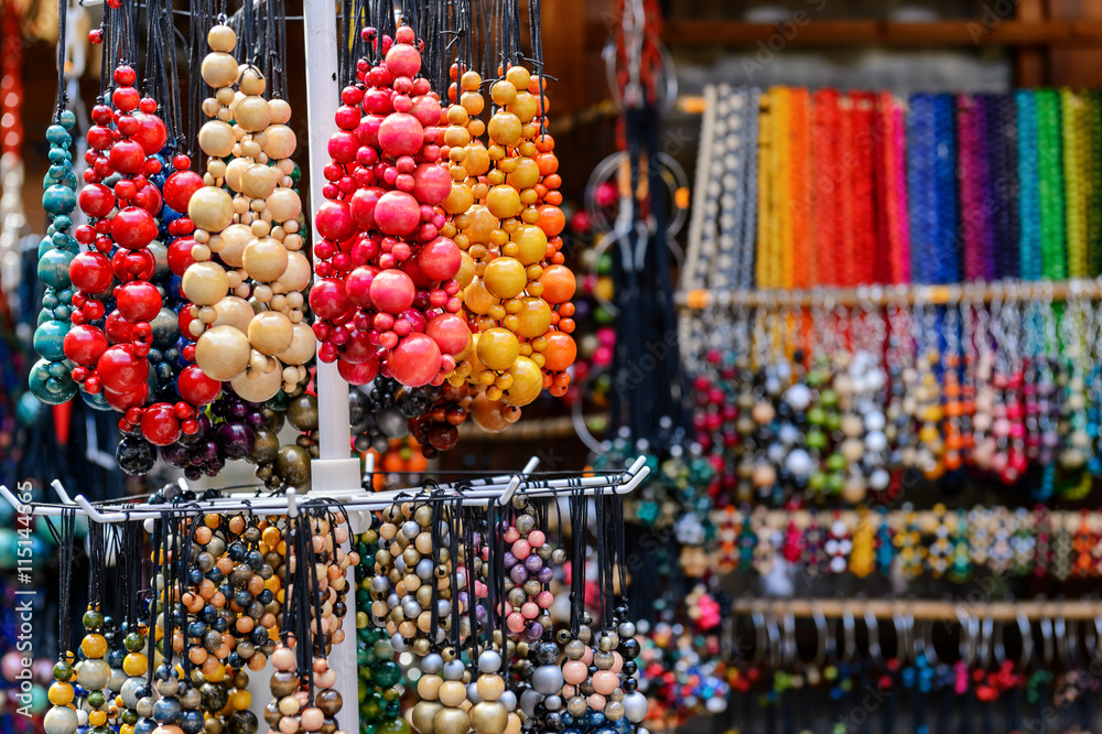 The variety of wooden colorful beads on street market.