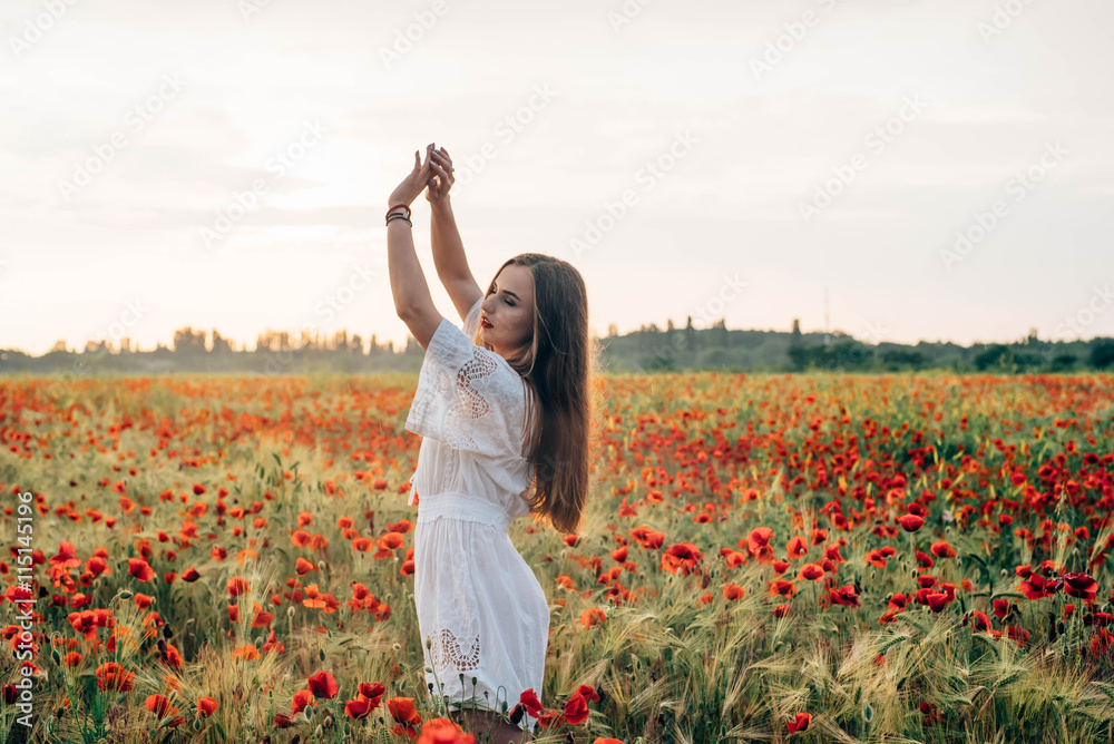 young caucasian female in poppy field enjoying the sunset young caucasian female in poppy field enjoying the sunset