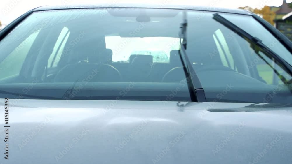 Slowmotion the view from outside on the car and the turn on windscreen wipers Slowmotion the view from outside on the car and the turn on windscreen wipers