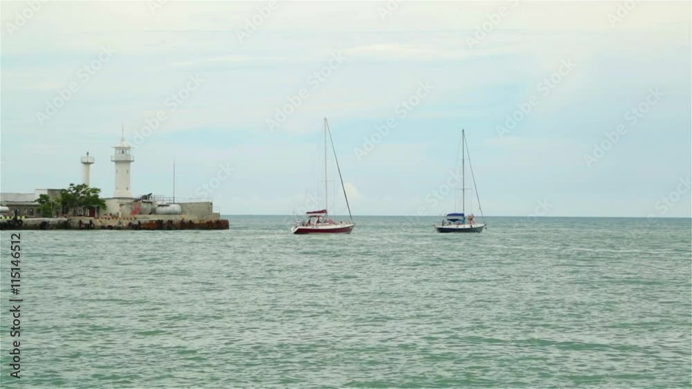 Sailing yacht out to sea from the port