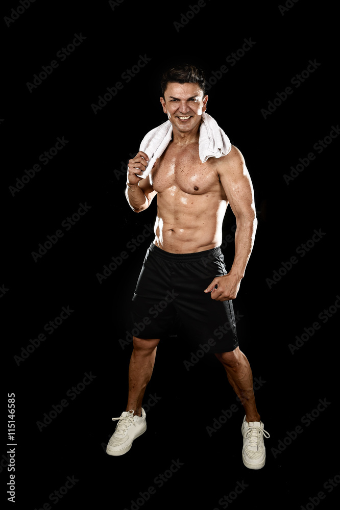 happy man with fit strong bodybuilder body posing corporate gym smiling with towel on neck happy man with fit strong bodybuilder body posing corporate gym smiling with towel on neck