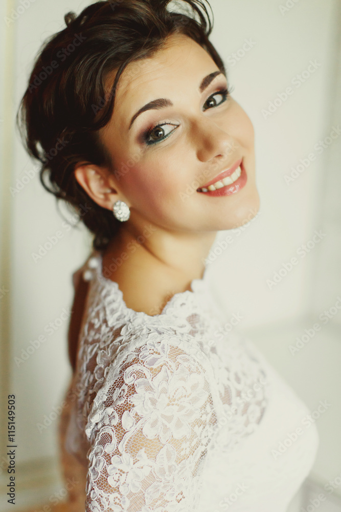 Pretty bride with green eyes smiles sparkling
