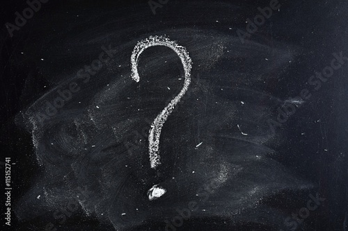 Question mark drawn in chalk on a blackboard