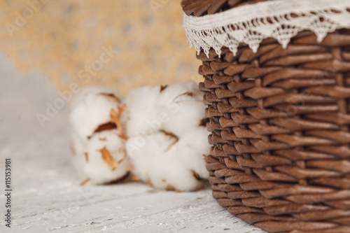 Empty wicker brown basket for fruit and bread with cotton flowe