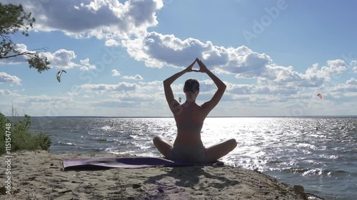 Wallpaper Mural Young healthy woman practicing yoga on the beach at sunset Torontodigital.ca