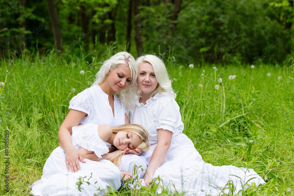 Happy family resting on the nature in the summer