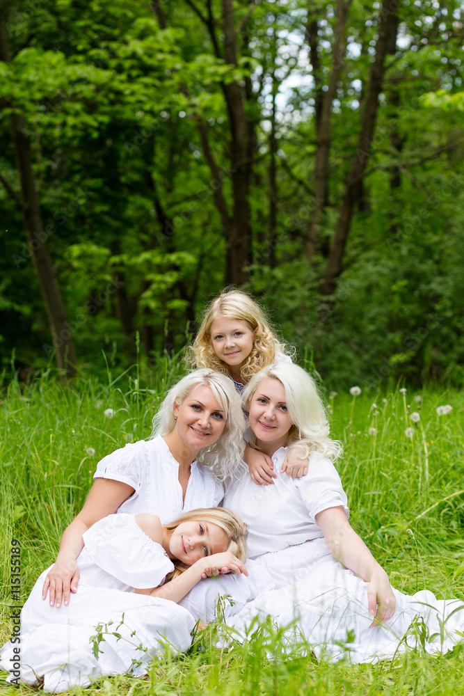 Fototapeta premium Happy family resting on the nature in the summer
