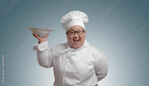 Happy Asian chef with plate in hand