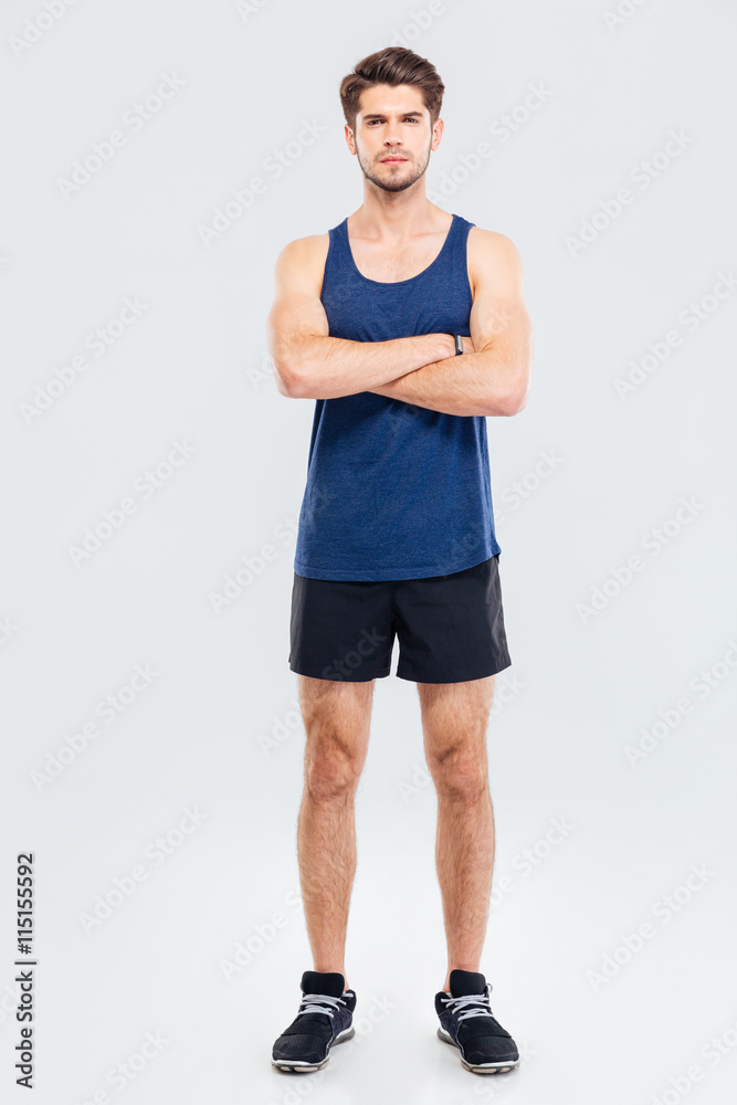 Full length portrait of a sportsman standing with hands crossed Full length portrait of a sportsman standing with hands crossed