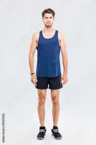 Full length portrait of a man in sportswear standing isolated