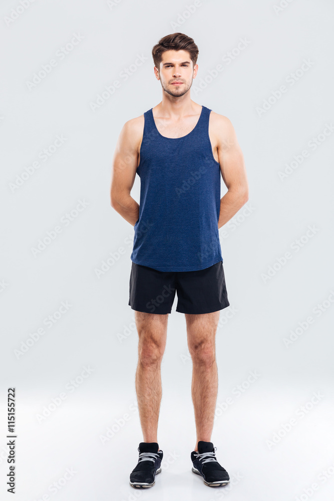 Full length of serious young sportsman standing Full length of serious young sportsman standing