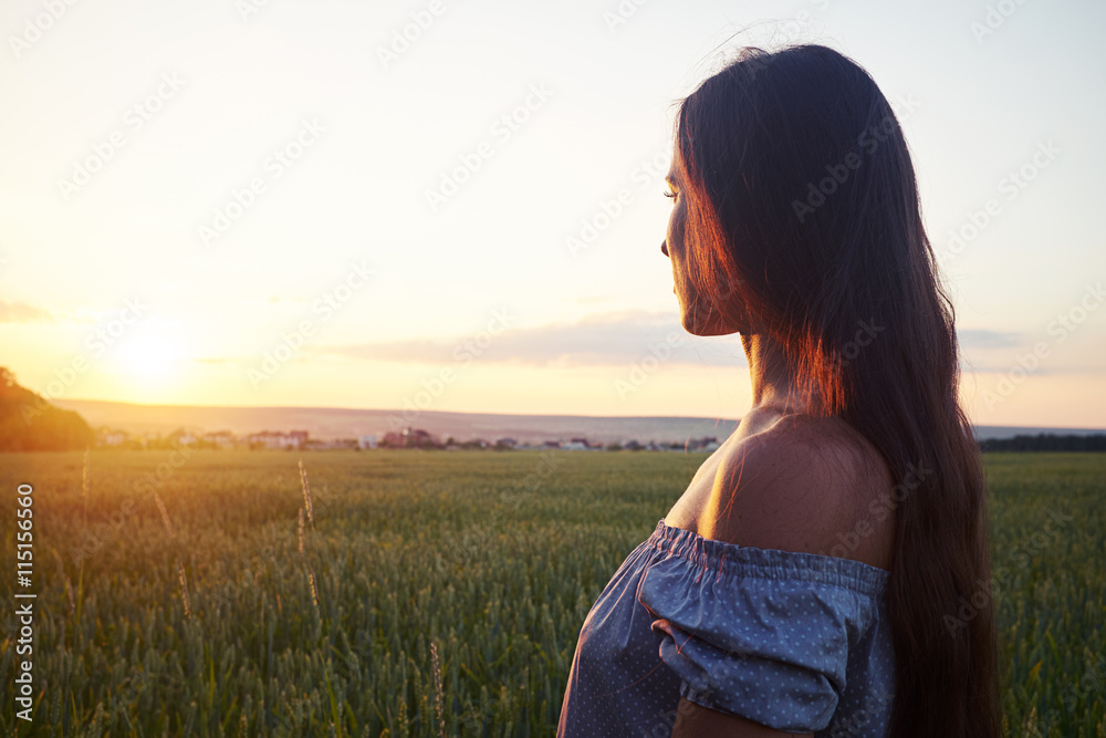 Side view portrait of beautiful dark-haired during sunset Side view portrait of beautiful dark-haired during sunset