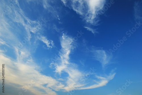 Blue sky with fluffy clouds background