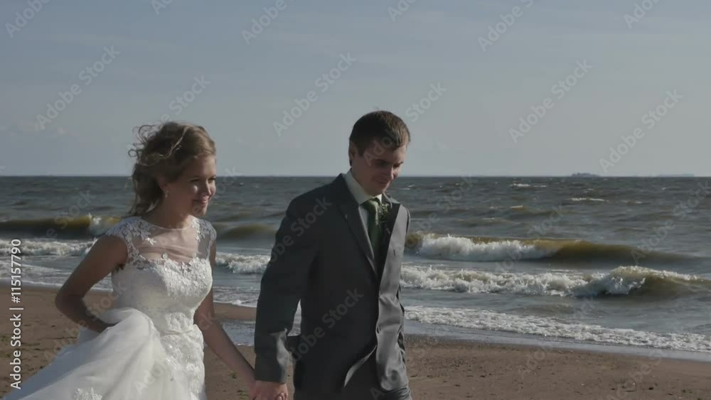 Couple walking on the beach holding hands Couple walking on the beach holding hands