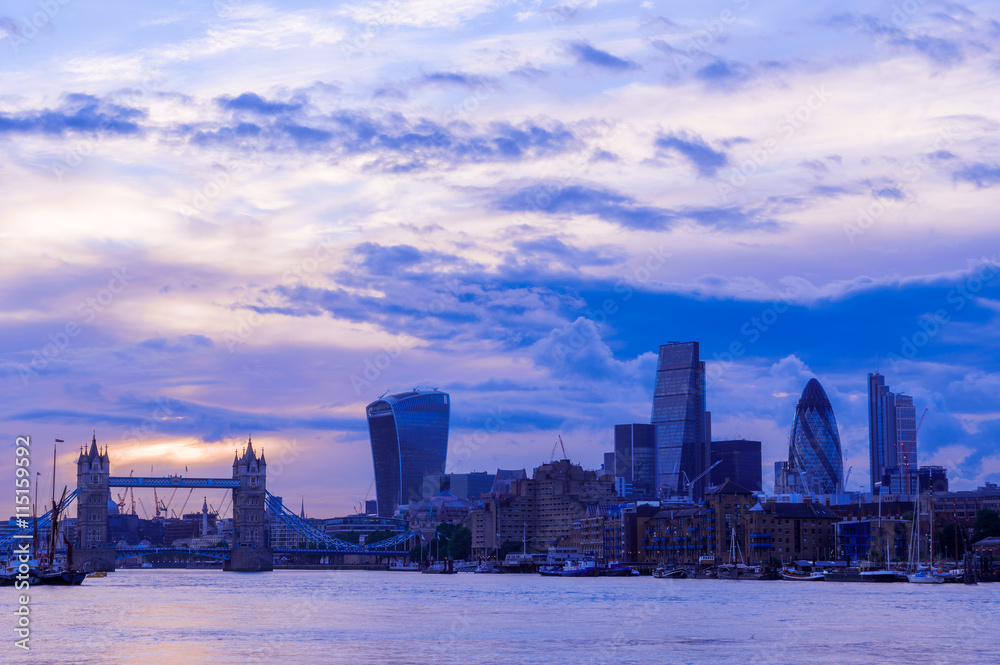 London cityscape including Tower Bridge against a purple sunset sky