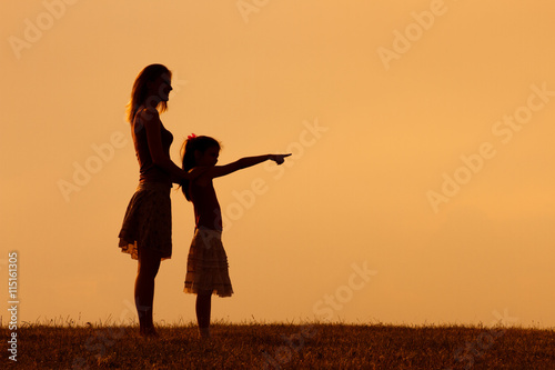 Mother and daughter enjoy spending time together in nature. 