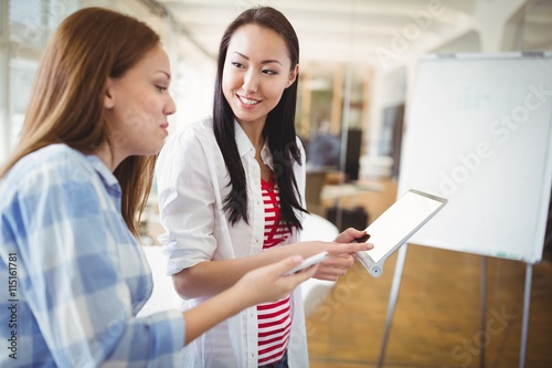 Female colleagues with digital tablet in creative office © WavebreakMediaMicro