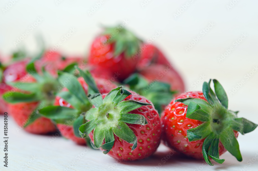 Group of of red ripe sstrawberry fruit on wooden board (Also kno - obrazy, fototapety, plakaty 