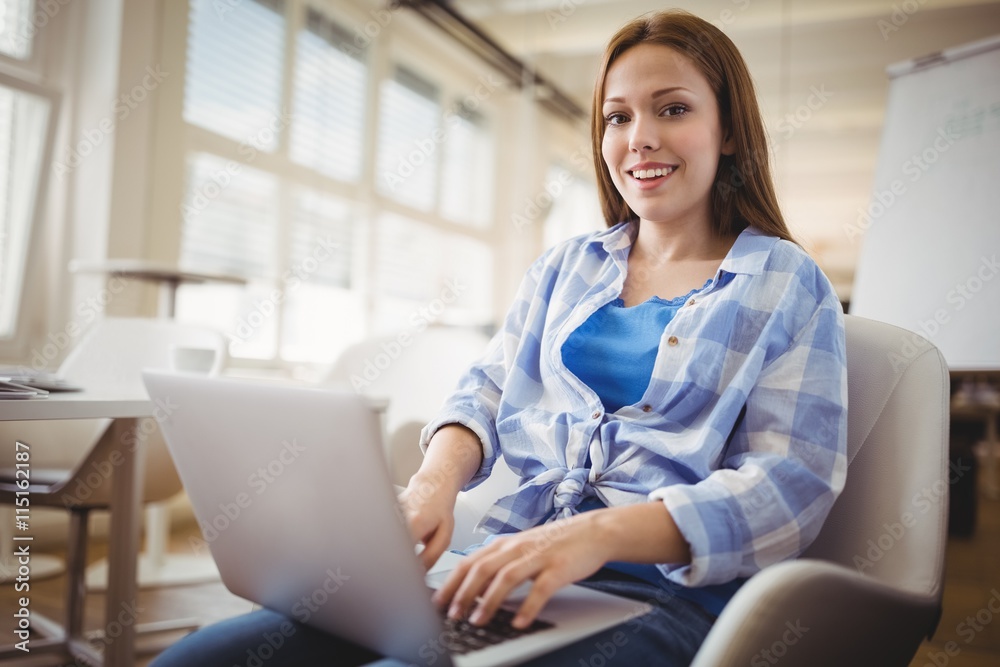 Portrait of businesswoman working on laptop in office Portrait of businesswoman working on laptop in office
