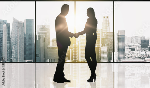 Photography business partners silhouettes making handshake