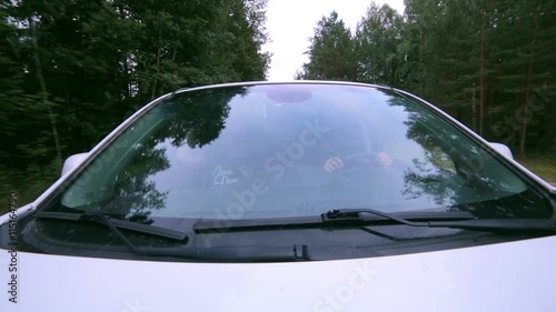 Reflection in Windscreen. Car drives through forest. On-board-camera. 1080p. photo