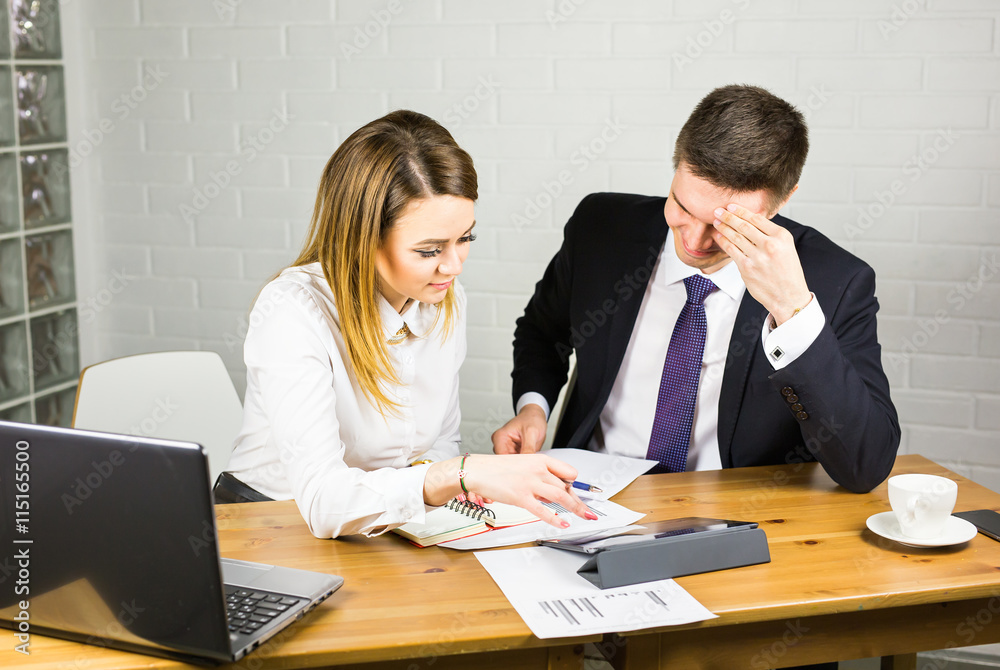 business couple working together on project at office business couple working together on project at office