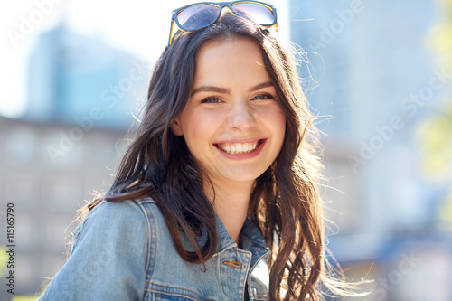 happy smiling young woman on summer city street photo