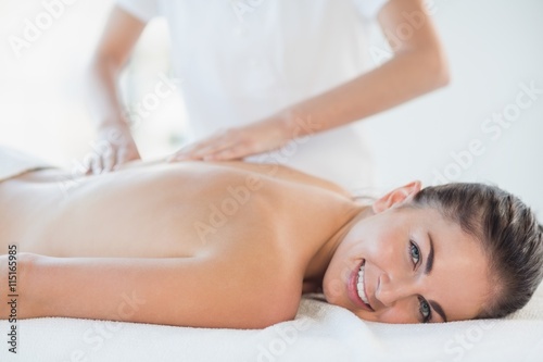 Portrait of happy woman receiving massage