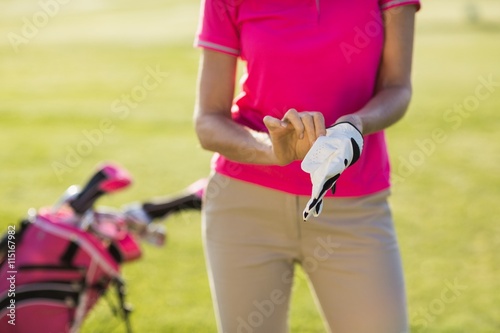 Midsection of woman wearing golf glove