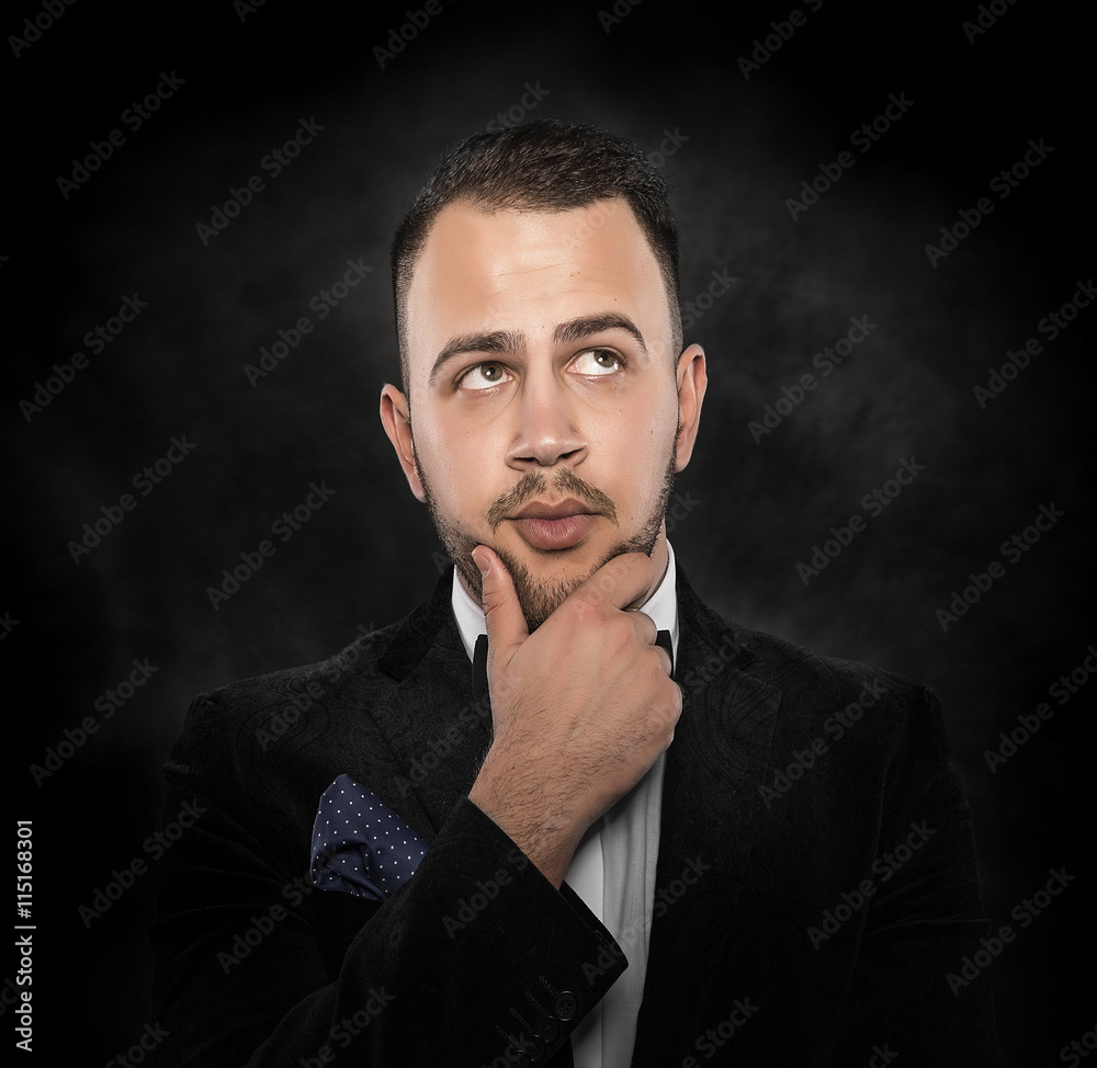 Man in black suit thinking or dreaming.
