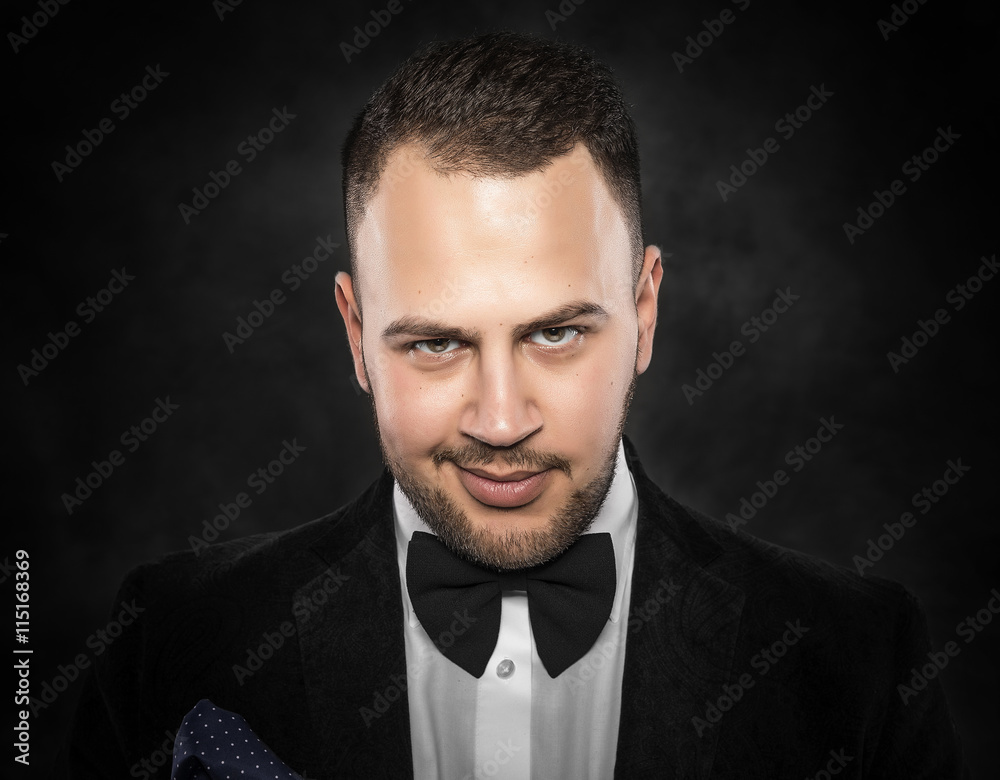 Fototapeta premium Young handsome man in black suit.