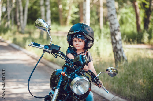 Little girl on a motorcycle. © kanashkin