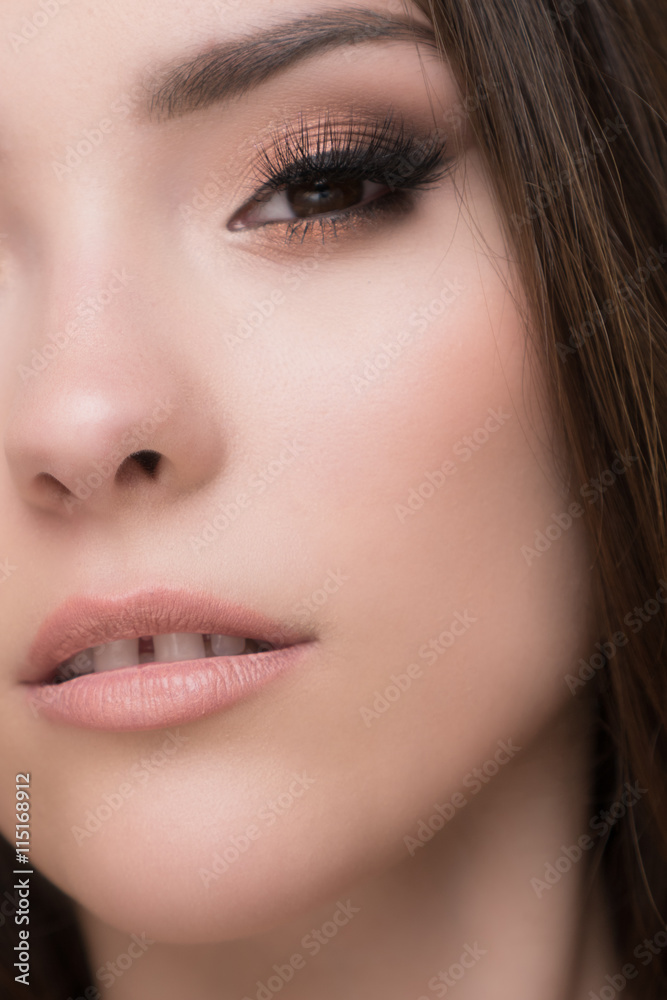 Closeup of beautiful brunette woman with pretty eyes and gap between teeth 