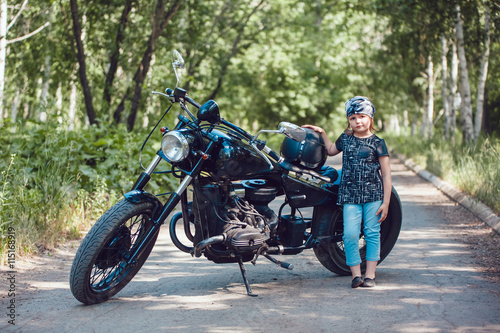 Little girl on a motorcycle.